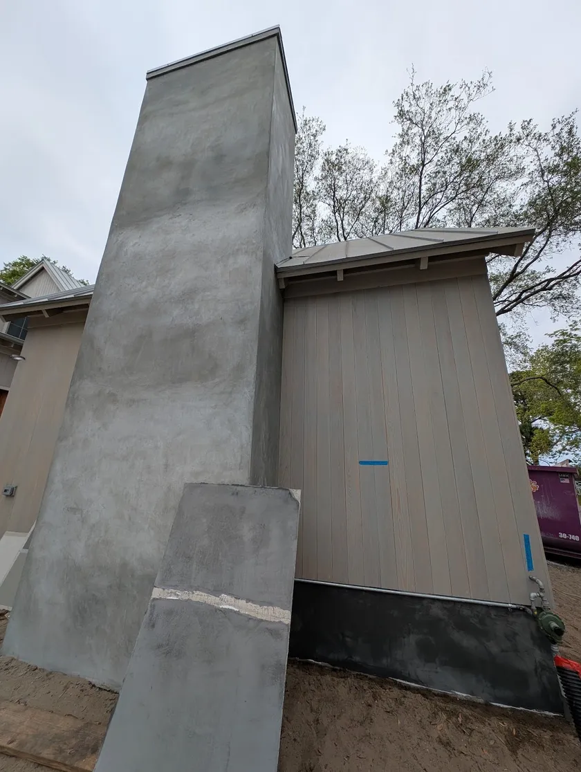 Hand-finished stucco chimney and siding elevation in progress