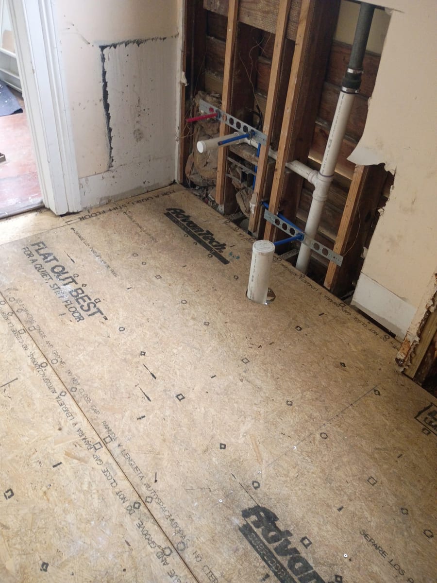 New engineered subfloor down with new drain lines rising through it